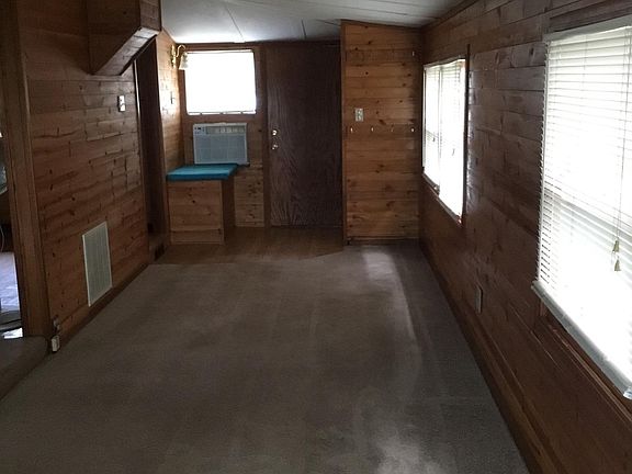 Living room with nice coat closet.