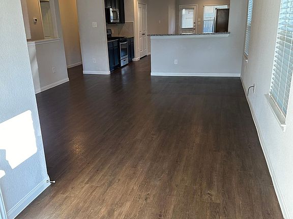 Large open living area, with coat closet on left of entryway.