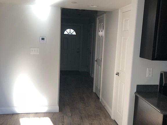 View from Kitchen has utility room, coat closet, steps to 2nd level, 1/2 bath & door to garage.