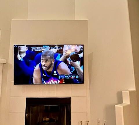 Main floor living area with fireplace and 4k Smart TV