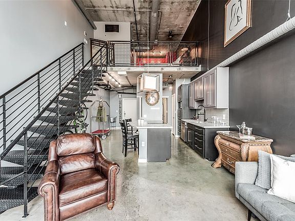 Great floor plan features open living, kitchen, half bath and laundry on first floor. Upstairs is the primary suite including full bath & walk-in closet! Entry door from building hallway can be seen in the background on the far left.