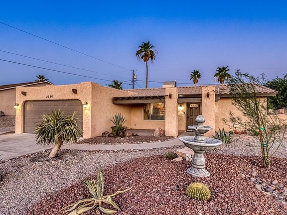 Beautiful southside curb appeal with low-maintenance desert landscaping and welcoming front entry.