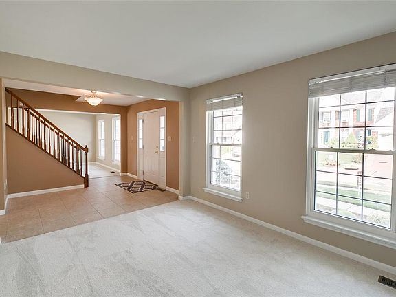 Looking from the office space into the entry, stairs leading to 4 bedrooms and a very large bonus room, across the way is what can be the formal living room.