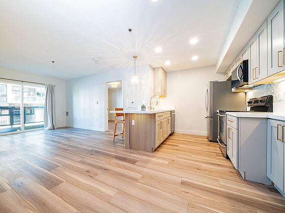 The spacious layout features an open concept kitchen, dining and living room areas.