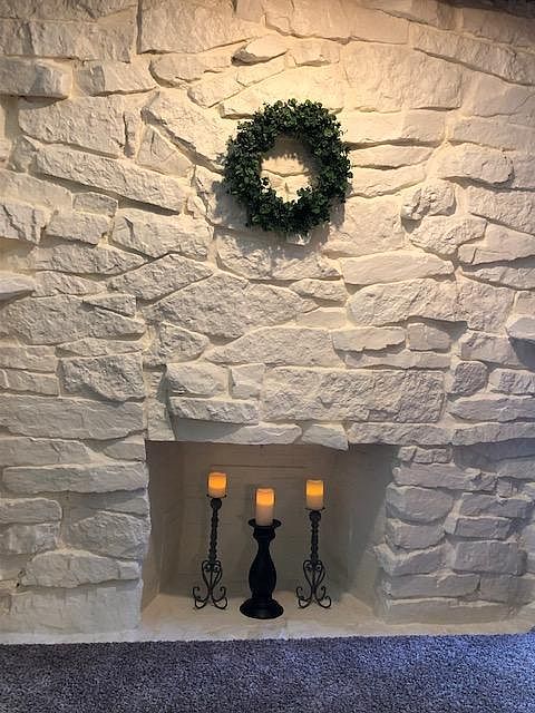 Beautiful painted stone fireplace adds cozy space in the living room.