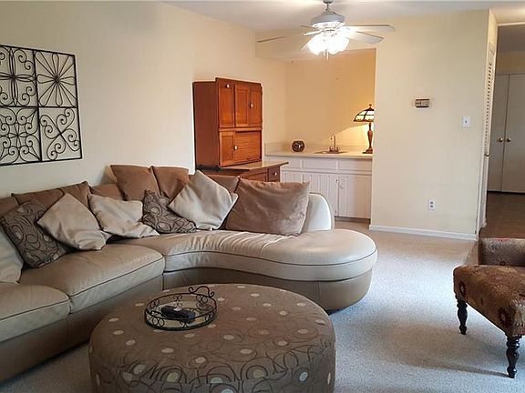 Living room with wood burning fireplace.Freshly painted walls throughout the condo.