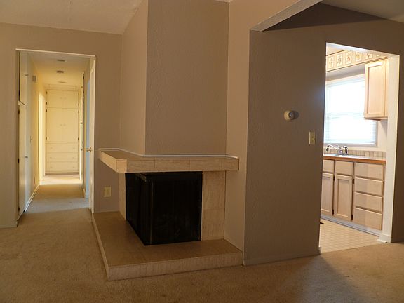 LR has marble faced corner fireplace