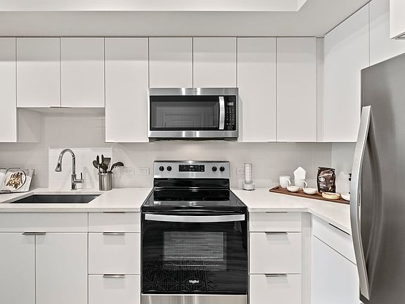 East Phase Kitchen with white cabinetry, white countertops, and stainless steel appliances