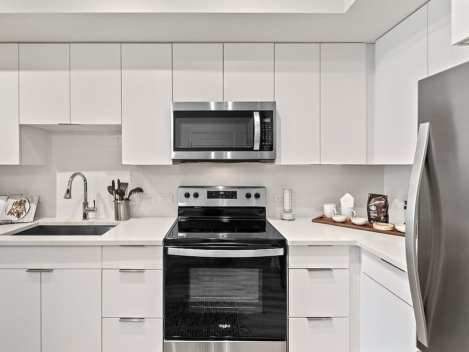 East Phase Kitchen with white cabinetry, white countertops, and stainless steel appliances