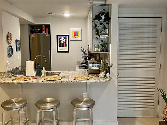 Living room area - stools included and storage closet to the right
