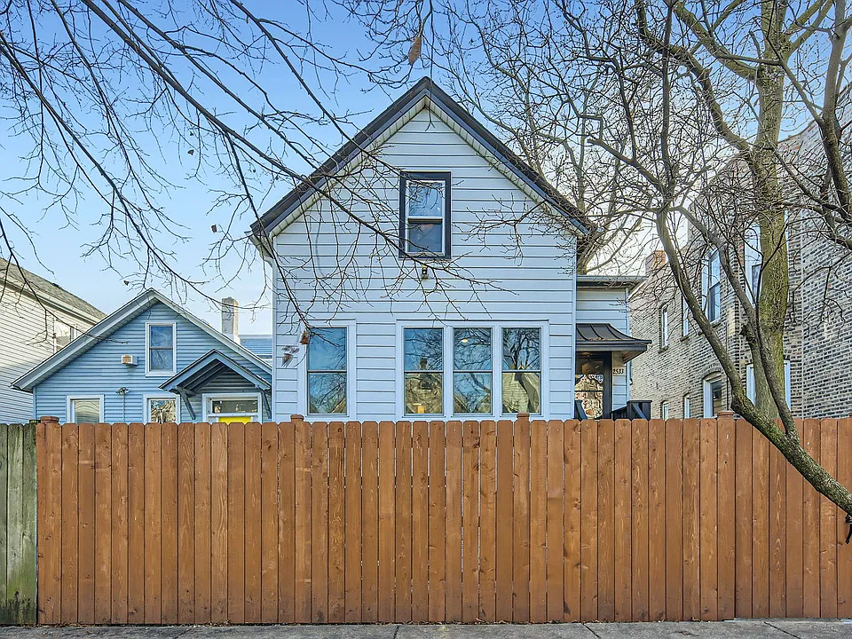 The home is located on a tree lined street.