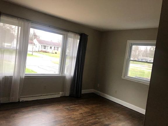 Front room has coat closet and hardwood floors
