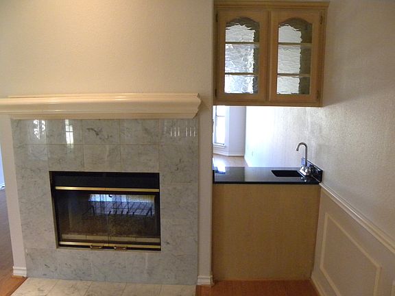 See-through fireplace and wetbar is between the formal and casual living areas. Perfect for entertaining.