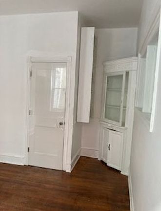 2nd dining room with built in cabinet and added shelving/book case. Room is next to Kitchen,