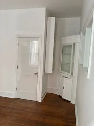 2nd dining room with built in cabinet and added shelving/book case. Room is next to Kitchen,