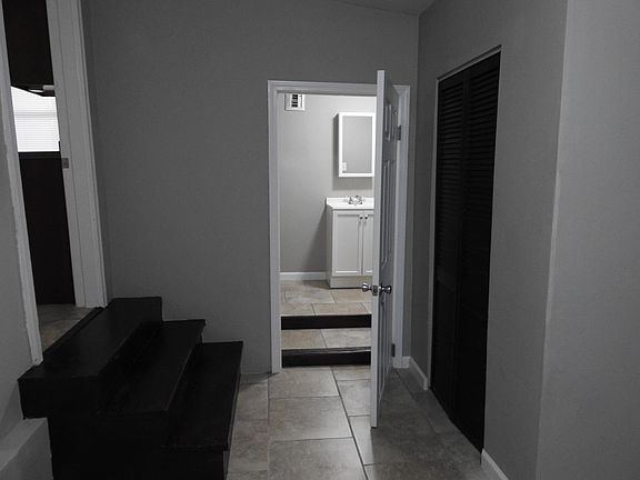 Main bedroom w/ view to 2nd bathroom/utility