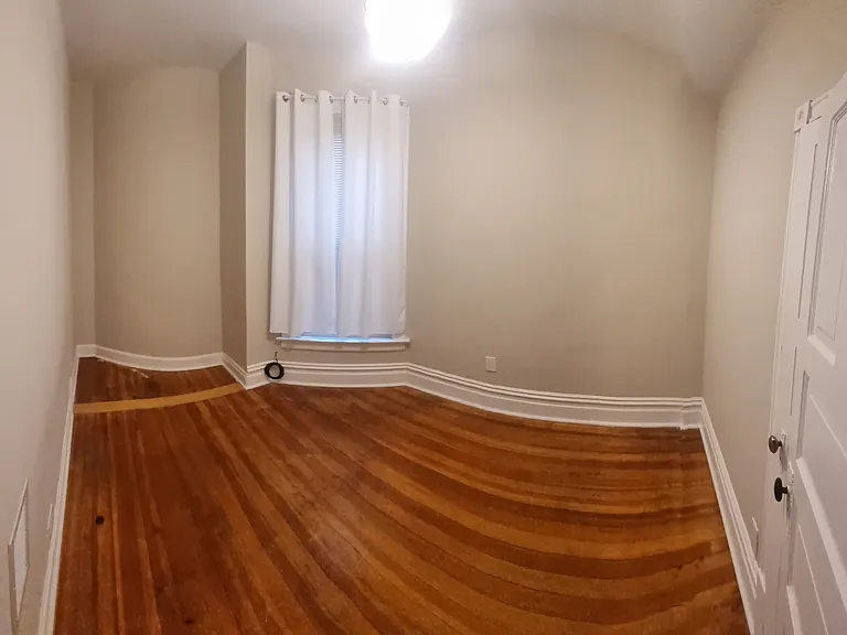Bedroom #2 9.5 feet by 11 feet

Full closet with door not pictured. 
 Taken from entry door, the panoramic view distorts floor pattern but gives you a better idea of room layout.