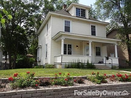 House Front - Summer 2012
						:
						Low-maint flowers, and a completely rebuilt porch have beautiful curb appeal.