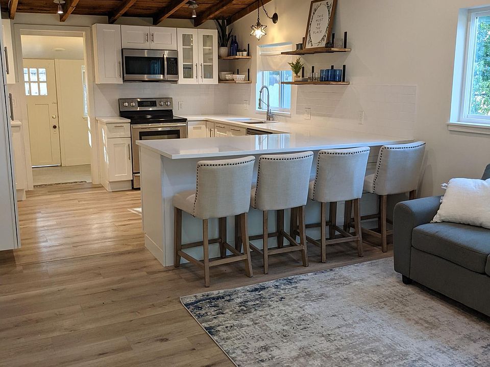 View from front door - open concept living room and kitchen with seating for 4.