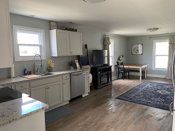 The table has changed from this image, as well as there is now a small loveseat sleeper sofa.
