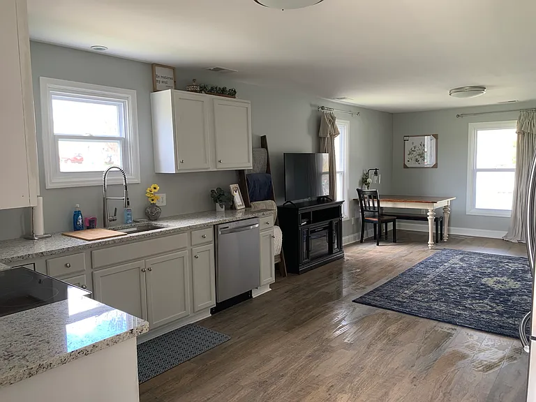 The table has changed from this image, as well as there is now a small loveseat sleeper sofa.