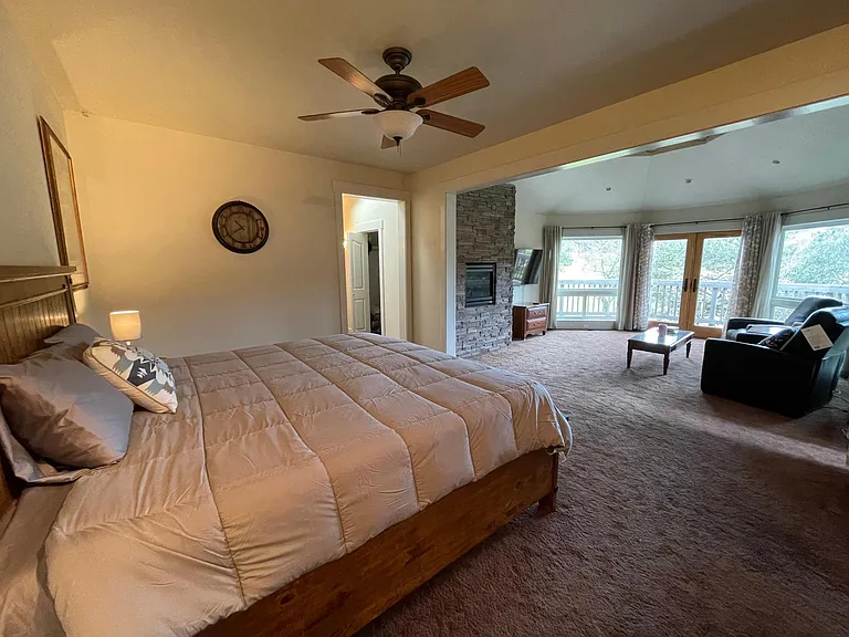 Master Suite on the lower floor with gas fireplace, flat screen TV and private seating area. Opens to a attached Patio.