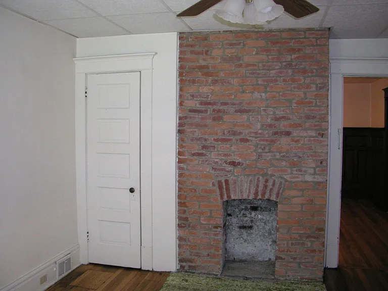 bedroom non-working fireplace and closet
