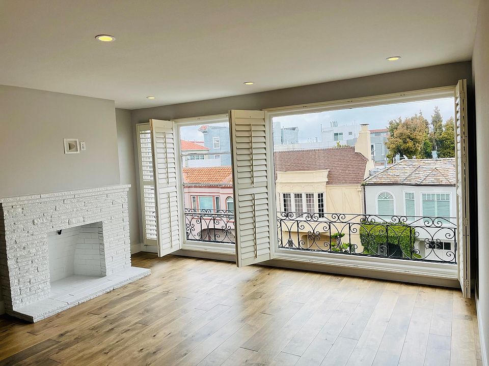 Living/Family room with fireplace and large plantation shutters.