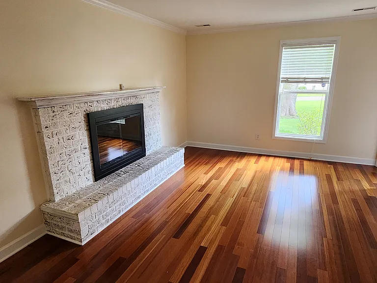 Living room with fireplace from dining area
