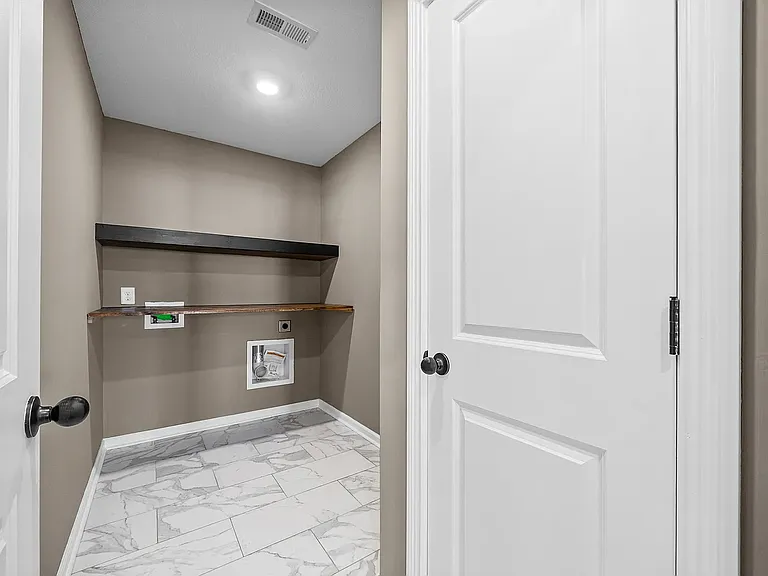 Washer dryer hook ups with a large shelf for folding!