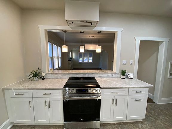 Kitchen pass through, quartzite countertops, all new lighting, remote-control range hood, and USB outlets.