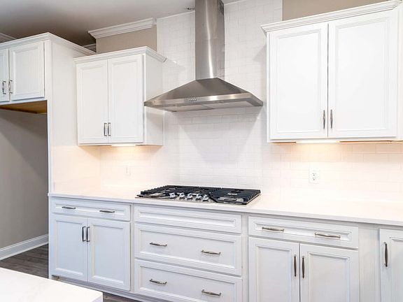 Prepare a tasty meal over the stainless stove with an included hood vent.