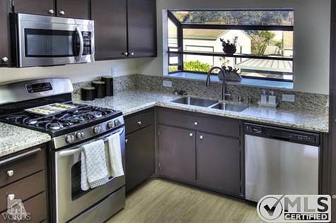 Remodeled kitchen with granite counters and new stainless appliances.