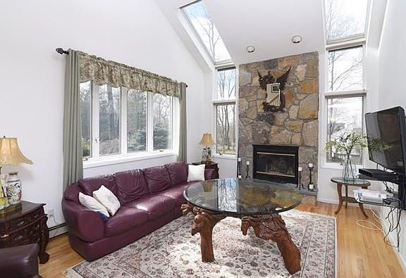 The entry foyer opens to the spectacular family room with cathedral ceilings and stone fireplace.