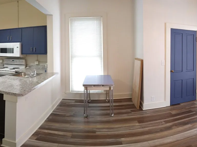 Standing in bedroom door, this view overlooks the living area/kitchen open floor plan.