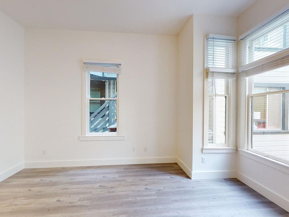 Living room with large windows and wood-like floors
