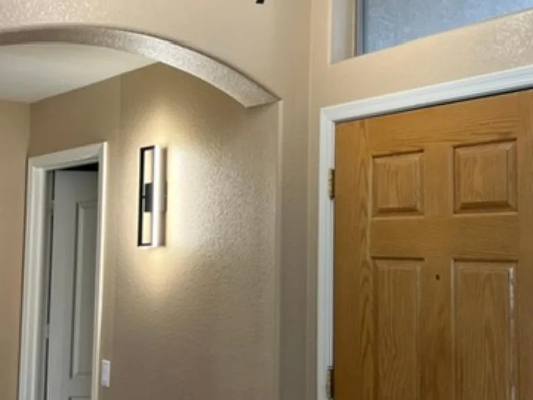 inside hallway off foyer to bedroom and bathroom and laundry room that leads to garage