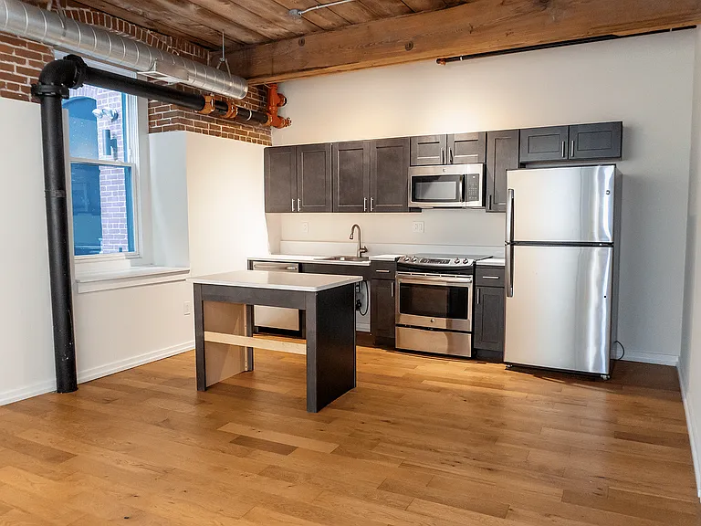 Experience urban elegance in this stylish loft kitchen, designed for both function and flair.