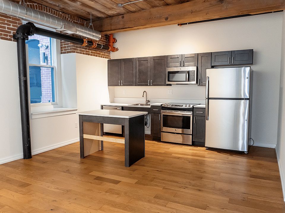 Experience urban elegance in this stylish loft kitchen, designed for both function and flair.