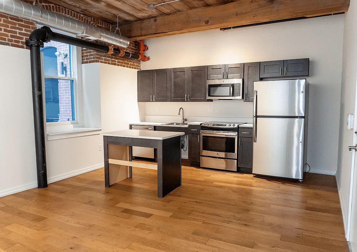 Experience urban elegance in this stylish loft kitchen, designed for both function and flair. - Cambridge Loft