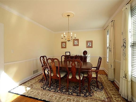 Formal dining room with two large windows that permit tons of natural light to enter. Additional features include hardwood floor