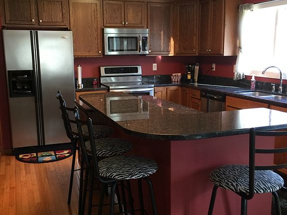 Kitchen bar island area with granite counter top. Stainless steal appliances.
