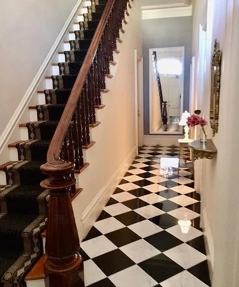 Hallway with original newell post and railing.