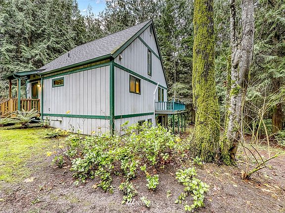 Looking from the back of home, wrap around deck faces the forest.