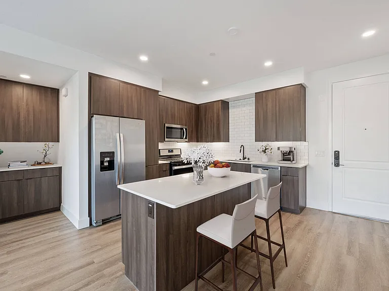 Cook in style with stunning kitchens featuring sleek quartz countertops and a chic backsplash.