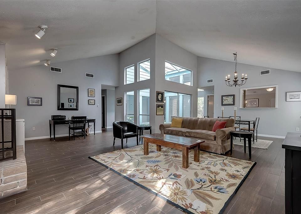 The nice size living room has tile-wood floors throughout and high ceilings.
