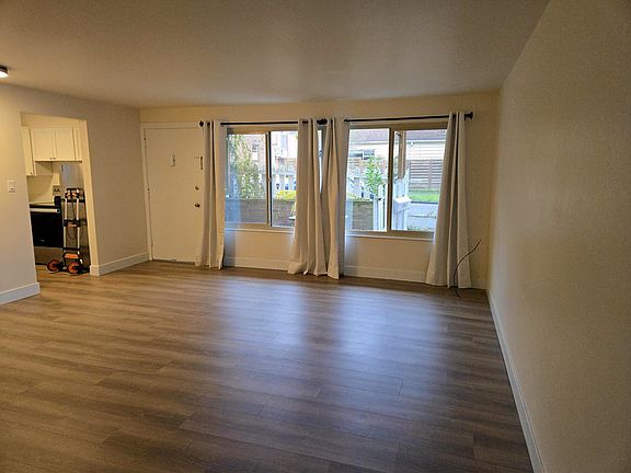 Spacious living room with big windows & lots of light