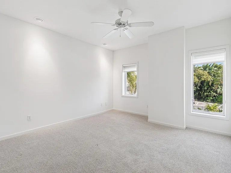 Master Bedroom with Tall Casement Windows overlooking Community Pool and Laurel Park.