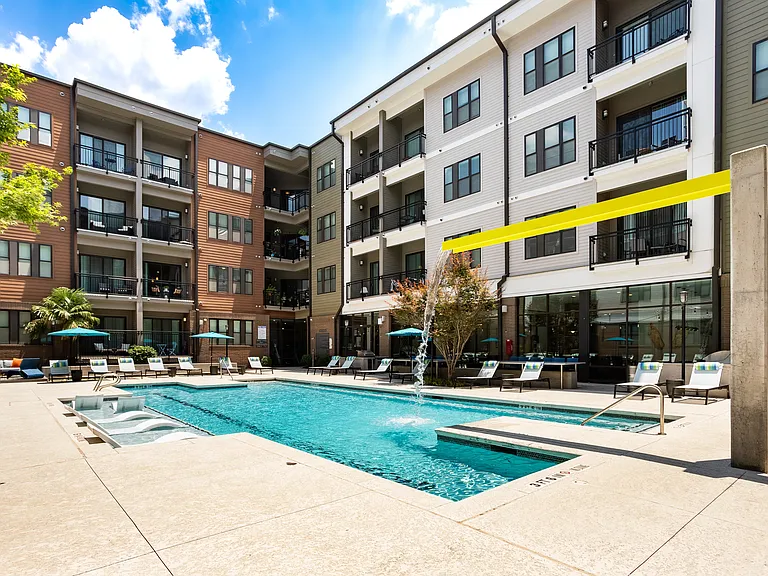Spacious Pool Deck with Waterfall Fountain, Sun Shelf, and Ample Poolside Seating