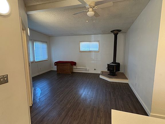 Spacious living room connected to kitchen. Fire stove will be removed from the property.